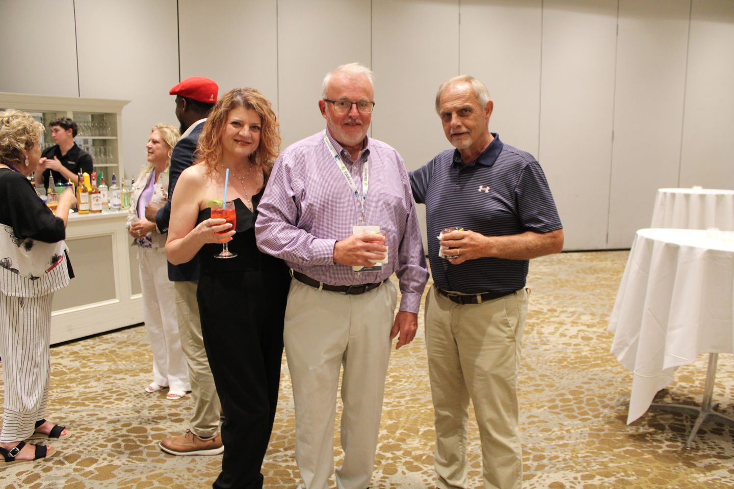 Attendees with drinks at the reception.