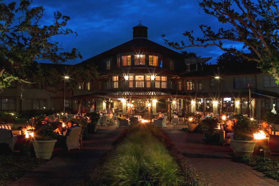 Evening gathering on a lantern-lit terrace outside the lodge at the annual Tenn-Tom Conference