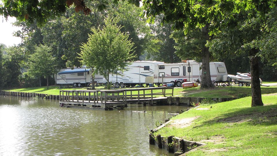 Campground with a small dock on a wooded shoreline